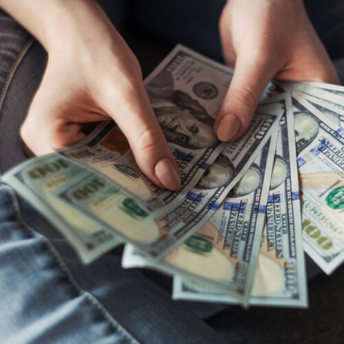 Hands counting fanned out money