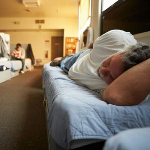 A man sleeping on a cot